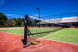 a tennis racket and balls on a tennis court at Horizons 404 in Jindabyne