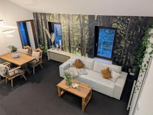 an overhead view of a living room with a couch and tables at Wald Villa Schönau in Schönau an der Brend