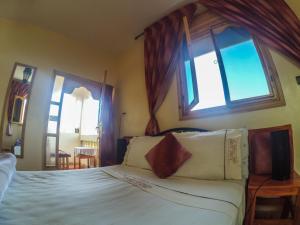Katil atau katil-katil dalam bilik di Maison Tigmi Ozro
