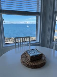 a white table with a view of the ocean at Seascape Luxury sea front apartment in Bangor