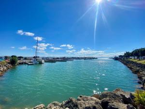 a view of a river with boats in the water at Knights' Retreat Napier in Napier