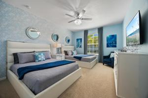 a bedroom with two beds and a ceiling fan at The Orlando Oasis in Davenport +82 photos
