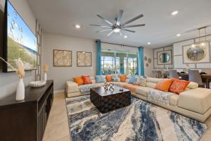 a living room with a couch and a tv at The Orlando Oasis in Davenport