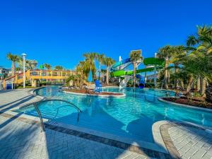 a swimming pool at a resort with a slide at The Orlando Oasis in Davenport
