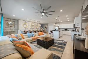 a large living room with a couch and a kitchen at The Orlando Oasis in Davenport