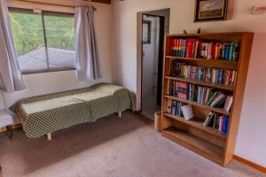a bedroom with a book shelf and a bed at Casa Vintage in San Carlos de Bariloche
