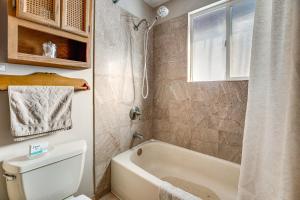 a bathroom with a tub and a toilet and a sink at Tranquil Ranch Home on 10 Acres in Leavenworth! in Leavenworth +25 photos