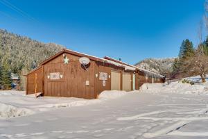 a building with snow on the ground in front of it at Tranquil Ranch Home on 10 Acres in Leavenworth! in Leavenworth