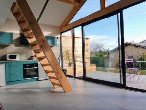 a kitchen with a wooden ladder in the middle of a house at La Casa Beau site in Gap