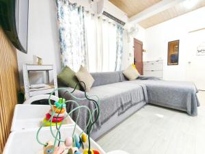 a living room with a bed and a window at Eco's Place GenTri - Cozy Family Bungalow in General Trias