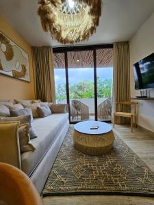 a living room with a couch and a table at Luxe Tulum Jacuzzi in Tulum