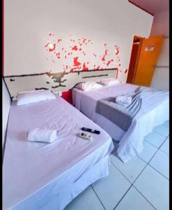 Łóżko lub łóżka w pokoju w obiekcie Pousada e Restaurante Kaizen