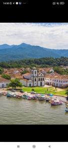 a group of boats are docked in a harbor at Pouso AJH in Paraty