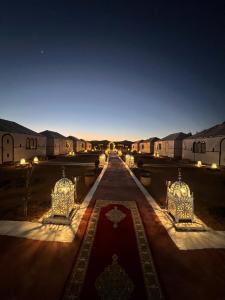a view of a compound at night with a red carpet at Alan Tent Merzouga in Merzouga