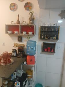 a kitchen with a counter with a mixer and plates at Alugyel 1 quarto,Aconchegante, ar de nostalgia in Fortaleza