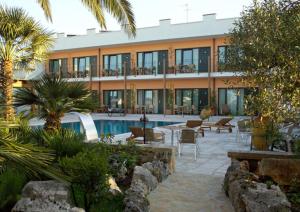 a resort with a swimming pool and a building at Hotel Cuor Di Puglia in Alberobello