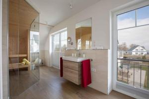 a bathroom with a sink and a large window at Holiday home in Altwarp 50009 in Altwarp +16 photos