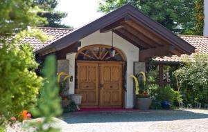 a house with a large wooden door in a yard at Studio in Bad Füssing - Bayern 53139 in Bad Füssing +4 photos