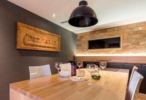 a dining room with a wooden table with wine glasses at Holiday home in Merisce - Istrien 53394 in Merišće