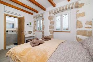 a bedroom with a large bed with towels on it at Holiday home in Grizane 51206 in Grižane +38 photos