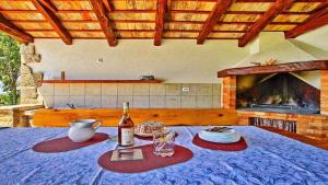 a table with a bottle of wine and glasses on it at Holiday home in Dolenja Vas - Istrien 51825 in Dolenja Vas