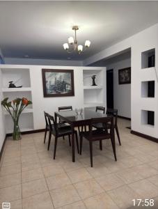 a dining room with a table and chairs at Siéntete como en tu casa in Tarija +17 photos