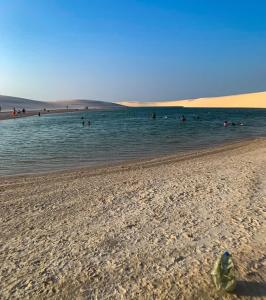 a group of people in the water at a beach at Estadia in São Luís