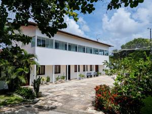 a large white building with a lot of windows at Casa Rio Doce in Natal