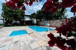 a swimming pool with a pool noodle in a yard at Casa Rio Doce in Natal
