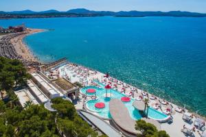 an aerial view of a beach with people and the water at Triple Room Solaris 12269b in Šibenik