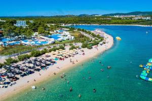 an aerial view of a beach with people in the water at Triple Room Solaris 12269b in Šibenik