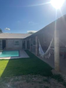 a house with a hammock in the yard at sitio para eventos in Caucaia