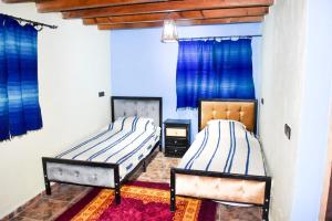 A bed or beds in a room at Dar zitouna