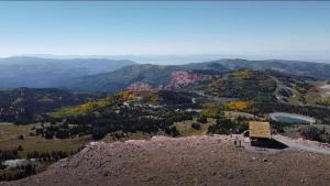 a view from the top of a mountain with a sign at 1BR 1BA for 5 Close to Outdoor Activities in Brian Head