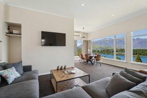 a living room with a couch and a table at The BIGGEST & BEST VIEWS 3 Bedrooms WALK To Town in Queenstown