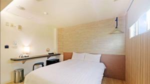 Postel nebo postele na pokoji v ubytování Huaxin Hotel