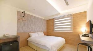 Postel nebo postele na pokoji v ubytování Huaxin Hotel