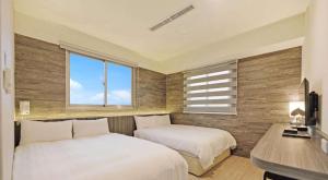 Postel nebo postele na pokoji v ubytování Huaxin Hotel