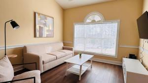 a living room with a couch and a table at Adorable 1BR condo with pool view at Magnolia in Myrtle Beach