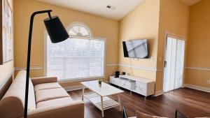 a living room with a couch and a table at Adorable 1BR condo with pool view at Magnolia in Myrtle Beach