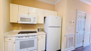 a kitchen with white appliances and a white refrigerator at Adorable 1BR condo with pool view at Magnolia in Myrtle Beach