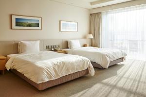 Voodi või voodid majutusasutuse Haevichi Hotel & Resort Jeju toas