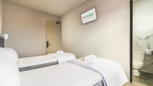 a hospital room with two beds and a mirror at Swiss-Belexpress Rest Area KM 260B in Bulakamba +6 photos