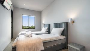 a bedroom with two beds and a window at Swiss-Belexpress Rest Area KM 260B in Bulakamba