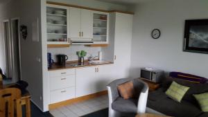 a living room with a couch and a kitchen at Parkresidenz Sanssouci in Zinnowitz