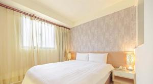 Postel nebo postele na pokoji v ubytování Huaxin Hotel