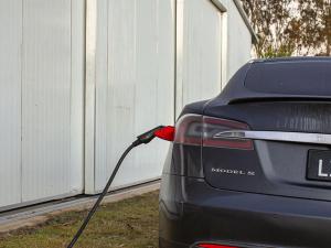a black car with a hose attached to the trunk at Crows Nest Tourist Park in Crows Nest
