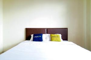 Postel nebo postele na pokoji v ubytování Urbanview Resort Villa Andy Tour Cisarua Puncak
