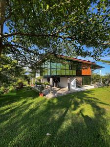 a building with a green lawn in front of it at 4 Simple Minimalistic Rooms at Sunset Lodge - Eco Valley Retreat 豐之谷 in Balung