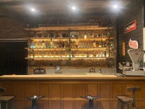 a bar with a lot of bottles of alcohol at La Pulperia in Capilla del Señor